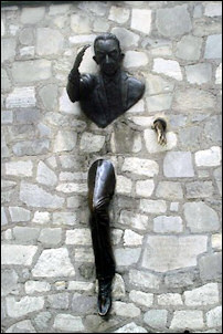 Statue in honor Le Passe-Muraille at Montmartre, Paris.