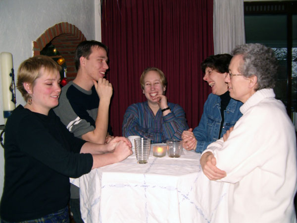 At the table.