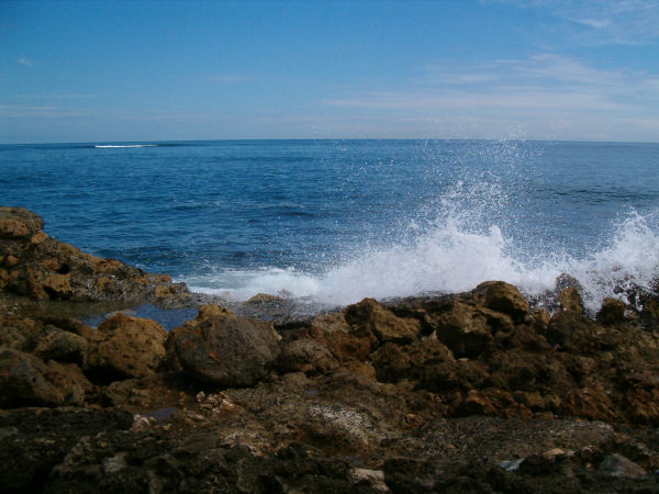 Waves coming over the rocks.