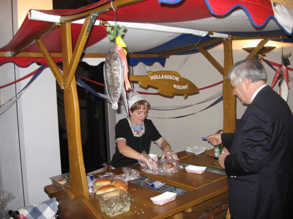 Herring and eel, being sold by a lady in a traditional Dutch costume.