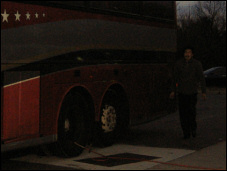 The bus driver adjusting the pressure in the tire.